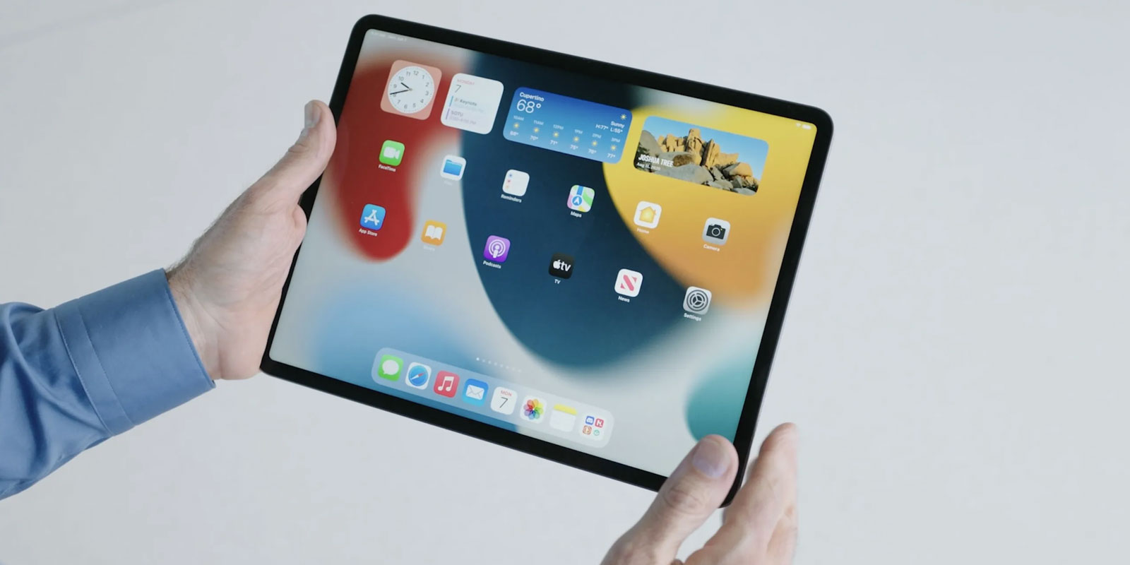A person holding an ipad in their hands.