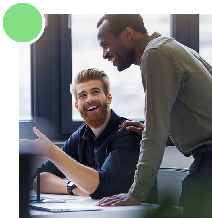 Two men are smiling and talking to each other.