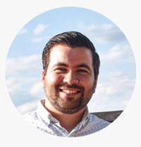 A man with a beard smiling for the camera.